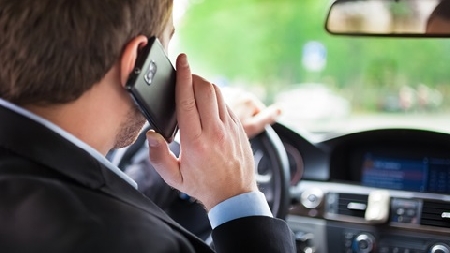 Console onorario del Sudafrica al volante col telefono in man...